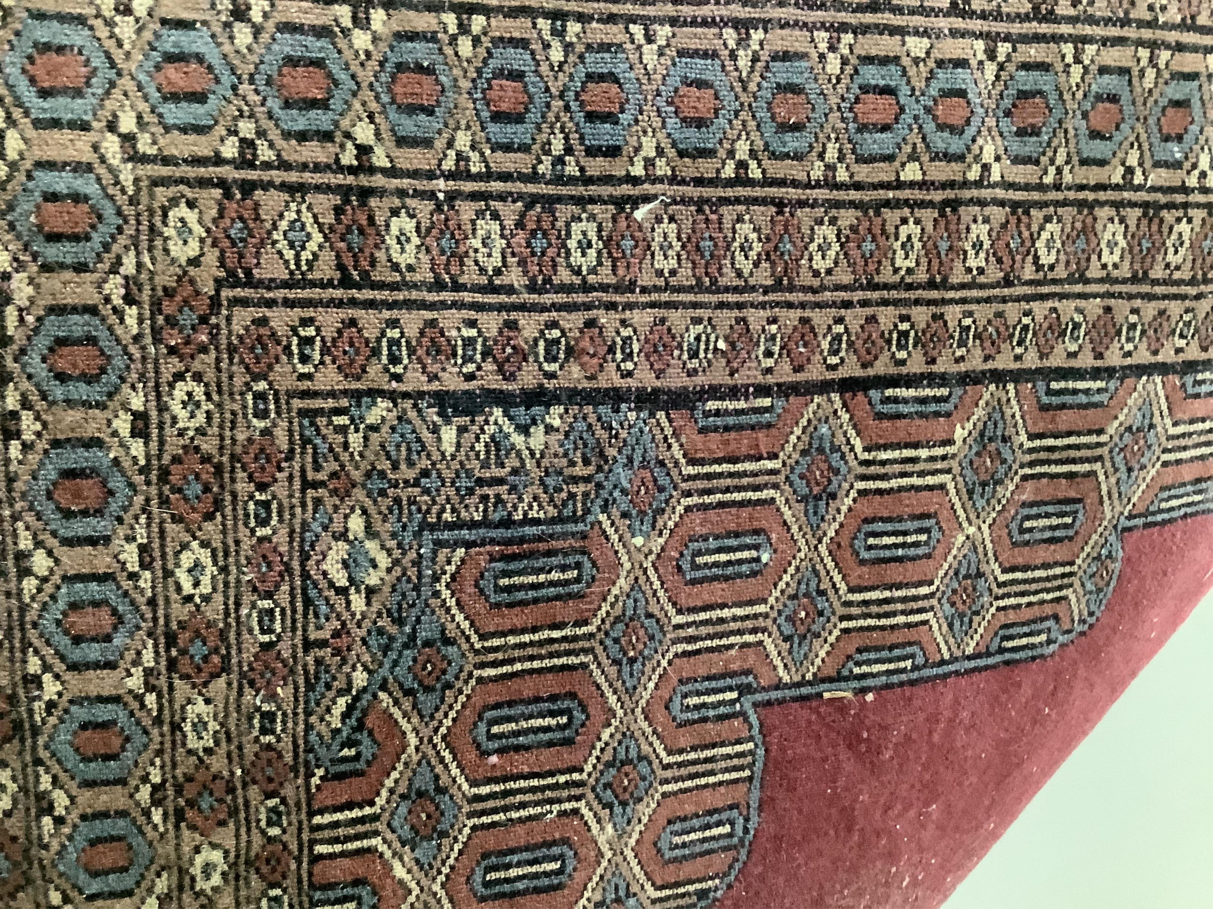 A modern Persian puce ground rug, 185 x 124cm. Condition - good